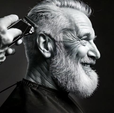 Senior gentleman receiving a quality haircut at Newhey barbers.