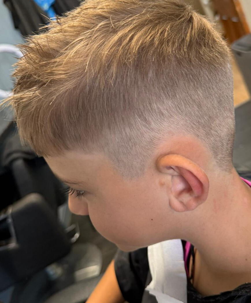 Boy's short back and sides haircut with a modern, textured top from Newhey barber.